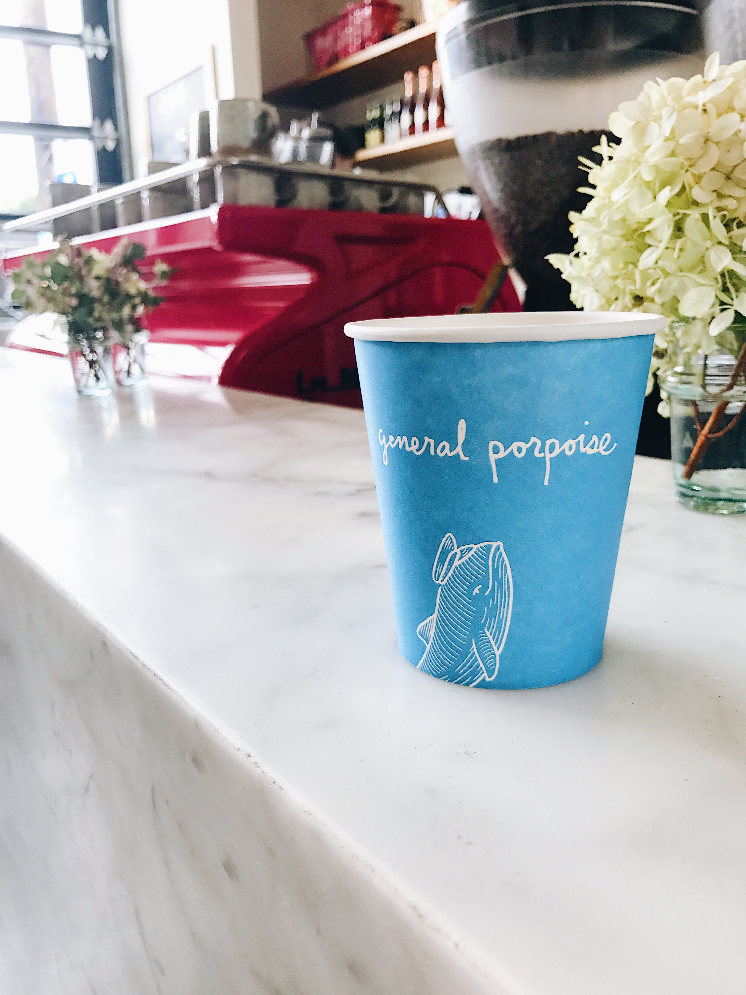 Blue to go coffee cup and hot pink La Marzocco espresso machine at General Porpoise | photo by Becca Risa Luna