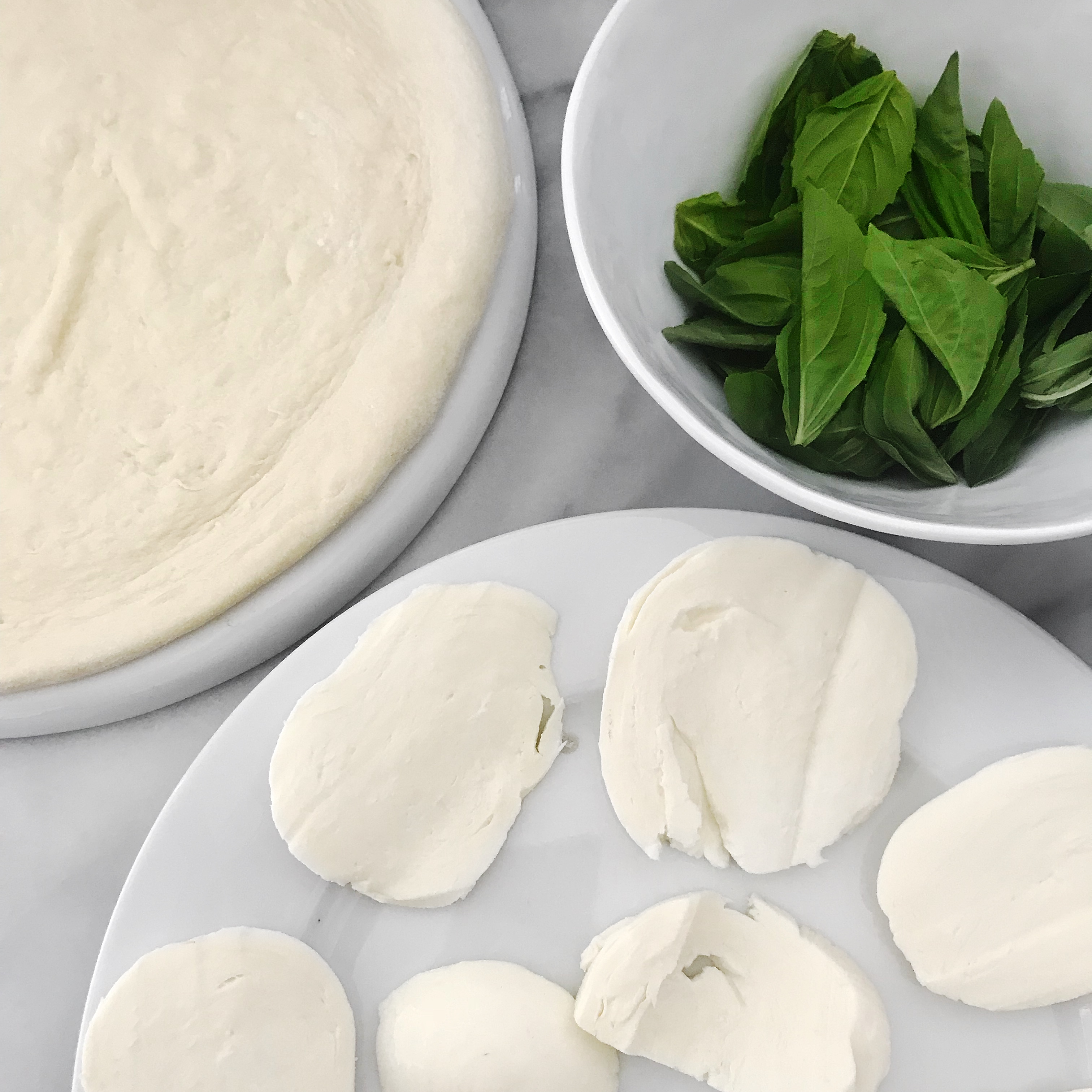 Homemade Pizza Ingredients: Mozzarella, Fresh Basil and Trader Joe's Pizza Dough 